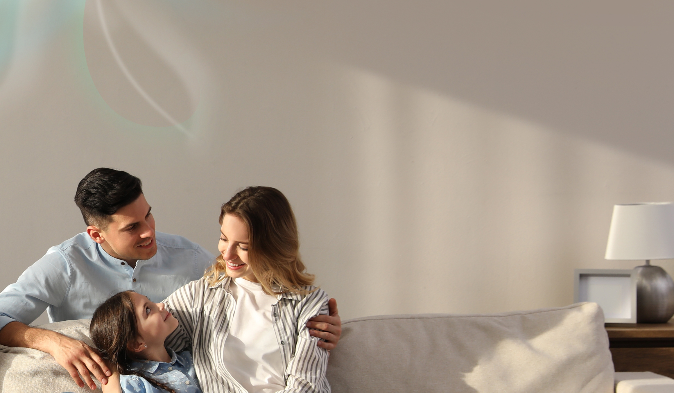 parents with daughter on sofa