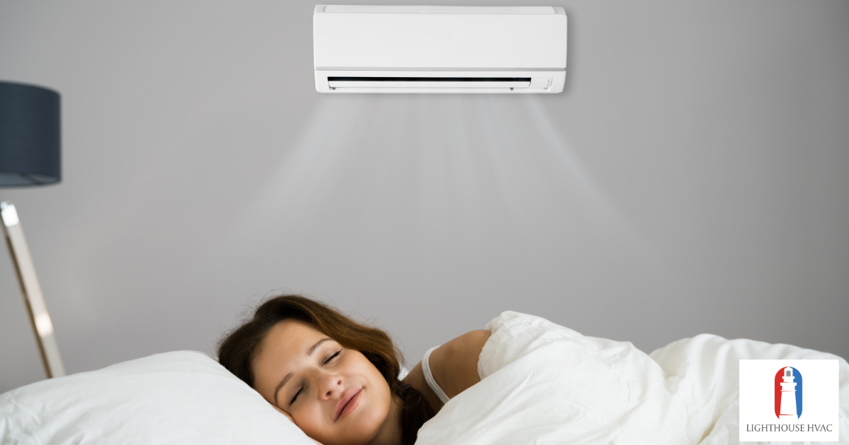 woman sleeping in bed with air conditioner on wall Lighthouse HVAC woman sleeping in bed with air conditioner on wall Lighthouse HVAC